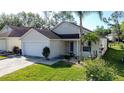 Inviting single-Gathering home with manicured lawn, a two-car garage, and a welcoming entrance at 2316 Paulette Dr, Haines City, FL 33844