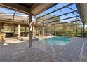 Screened-in pool area with covered patio and spa, perfect for outdoor relaxation and entertainment at 2515 Ridgewind Way, Windermere, FL 34786