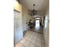 Inviting tiled foyer with high ceilings, decorative lighting, and direct access to the main living areas at 2678 Autumn Creek Cir, Kissimmee, FL 34747