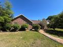 Well-maintained brick home with lush greenery and a brick walkway at 3725 Blossom St, Kissimmee, FL 34746