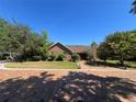 Lovely brick home with mature trees and landscaping creating curb appeal at 3725 Blossom St, Kissimmee, FL 34746