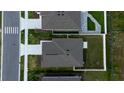 Birds-eye view of the house showcasing the roof, landscaping, and proximity to neighboring homes at 381 Singing Sands Cir, Lake Wales, FL 33859