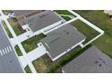 Aerial view of the house displaying its backyard space and the layout of the community at 381 Singing Sands Cir, Lake Wales, FL 33859