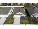 Overhead shot of the property with a well-manicured lawn and a clear view of the neighborhood at 381 Singing Sands Cir, Lake Wales, FL 33859