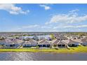 Gorgeous aerial view of lakeside homes surrounded by lush lawns and white fences in a Gathering-friendly neighborhood at 3848 Cabo Rojo Dr, St Cloud, FL 34772