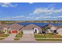 Beautiful lakeside homes feature well-manicured lawns, two car garages, and lovely landscaping with lake views at 3848 Cabo Rojo Dr, St Cloud, FL 34772