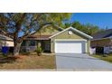 This home has an attached garage, lovely lawn, and mature landscaping at 4419 Great Harbor Ln, Kissimmee, FL 34746