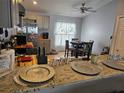 Well-lit kitchen featuring stainless steel appliances, tile floor and breakfast table with chairs at 633 Kangaroo Dr, Kissimmee, FL 34759