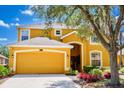 Charming home featuring a two-car garage and well-manicured landscaping at 917 Orange Cosmos Blvd, Davenport, FL 33837
