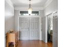 Inviting foyer featuring tiled floors, neutral paint, and a decorative light fixture at 10986 Ledgement Ln, Windermere, FL 34786