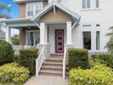 Welcoming front entrance with a colorful door and meticulously maintained landscaping at 13831 Briand Ave, Orlando, FL 32827