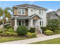Inviting two-story home featuring a well-maintained lawn and decorative shrubbery at 13831 Briand Ave, Orlando, FL 32827