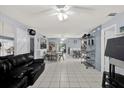 Spacious living room boasts tile floors, light blue walls, and a view into the dining area and kitchen at 139 Acapulco Dr, Kissimmee, FL 34743