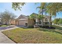 Lovely single-Gathering home with a three-car garage, palm trees, and well-maintained lawn at 1502 Fern Bay Ct, Orlando, FL 32824