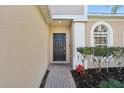 Inviting front entrance with a black door, brick walkway, and manicured landscaping at 1502 Fern Bay Ct, Orlando, FL 32824