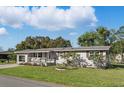 Inviting single-story home with a lovely front porch and lush green lawn at 1622 Marlin St, St Cloud, FL 34771