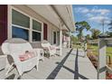 Relaxing front porch with wicker chairs, perfect for enjoying the outdoors at 1622 Marlin St, St Cloud, FL 34771