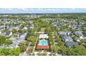 An aerial view shows a community pool, common areas, and single-Gathering homes in the residential neighborhood at 205 Norfolk Pl, Celebration, FL 34747