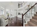 Open-concept living room with stairs, high ceilings, and modern furnishings at 205 Norfolk Pl, Celebration, FL 34747