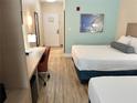 Comfortable guest room featuring two beds, a desk, and modern amenities for a pleasant stay at 3000 Maingate Ln # 330, Kissimmee, FL 34747