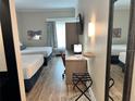Well-appointed guest room with two beds, a desk, and a cozy seating area for a relaxing getaway at 3000 Maingate Ln # 330, Kissimmee, FL 34747