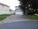 Charming two-story home featuring mature trees and a well-maintained front lawn at 3007 Bransbury Ct, Kissimmee, FL 34747