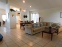 Open-concept living room with tile flooring, high ceilings, and an adjacent dining area at 3007 Bransbury Ct, Kissimmee, FL 34747