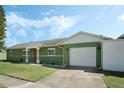 Charming single-story home with attached garage and well-manicured lawn under a partly cloudy sky at 3030 Little Sound Dr, Orlando, FL 32827