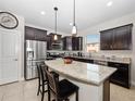 Modern kitchen with granite countertops, stainless steel appliances, and center island at 3675 Cabo Ln, St Cloud, FL 34772