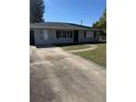 Lovely home with long driveway and well-maintained lawn leading up to the front door at 414 Dakota Ave, St Cloud, FL 34769