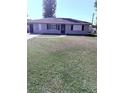 Charming single-story home with a well-kept lawn, neutral paint, and a paved walkway at 414 Dakota Ave, St Cloud, FL 34769