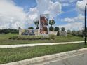 Beautiful community sign for Story Creek with lush landscaping and blue sky background at 4497 Bluff Oak Loop, Kissimmee, FL 34746