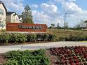 Community sign for Havenfield @ Crossprairie with landscaped flowerbeds and green space at 4952 Shady Pines Dr, St Cloud, FL 34772