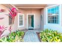 Open entryway leading into a home with tiled floors, neutral walls, and outdoor landscaping at 531 Barcelona Dr, Poinciana, FL 34759