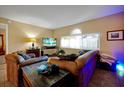 Cozy living room featuring comfortable seating, tile floors, and a bright window, perfect for relaxation at 541 Rebecca Dr, St Cloud, FL 34769