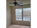 Bedroom with neutral walls, carpet, ceiling fan, and windows with blinds at 6148 Westgate Dr # 302, Orlando, FL 32835