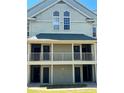 Close up of exterior of a two-story condo featuring neutral tone paint and double stairways and balconies at 6148 Westgate Dr # 302, Orlando, FL 32835