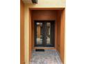 Inviting double front doors framed by stylish orange columns on a brick entry at 619 Tapatio Ln, Kissimmee, FL 34759