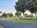 Bermuda Dunes Luxury Condominiums sign with manicured landscaping, palm trees, and golf cart crossing at 7240 Westpointe Blvd # 1122, Orlando, FL 32835