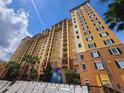 Tall condo building featuring balconies with great views, surrounded by lush tropical landscape at 8125 Resort Village Dr # 5310, Orlando, FL 32821