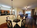Cozy living area with dining table, sliding door to a private balcony, and adjacent kitchen at 8125 Resort Village Dr # 5310, Orlando, FL 32821