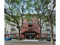 Attractive building entrance framed by trees and street lights at 911 N Orange Ave # 142, Orlando, FL 32801