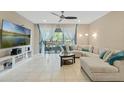 Comfortable living room with a large sectional sofa, tile floors, and sliding glass doors at 10871 Corsican St # 21, Orlando, FL 32824