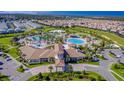 Aerial view of a community showcasing a large resort-style pool, clubhouse, and surrounding residential area at 1137 Drop Ln # 1137, Davenport, FL 33896