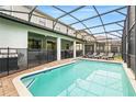 A stunning screened-in pool with ample space for lounge chairs and outdoor entertainment at 1432 Rolling Fairway Dr, Davenport, FL 33896