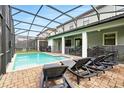 Inviting screened-in pool area with lounge chairs, perfect for relaxing and enjoying the outdoors at 1432 Rolling Fairway Dr, Davenport, FL 33896