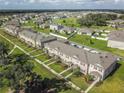 Expansive community with townhomes surrounded by lush green landscaping at 1459 Rylee Rock Way, Kissimmee, FL 34744