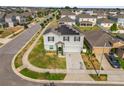 Aerial view of a gray two-story home with solar panels in a residential neighborhood with manicured lawns at 204 Taft Dr, Davenport, FL 33837