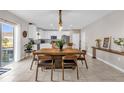 Open floor plan showcasing a kitchen with white cabinets and stainless steel appliances, adjacent to a dining area at 204 Taft Dr, Davenport, FL 33837