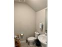 Cozy half-bathroom featuring a pedestal sink, neutral walls, and tiled floors at 2040 Milkweed St, Ocoee, FL 34761